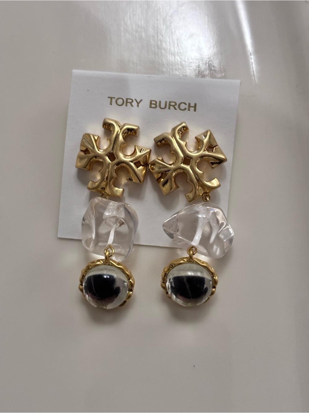 Tory Burch Gold Logo Drop Earrings with Clear Resin and Black Cabochons